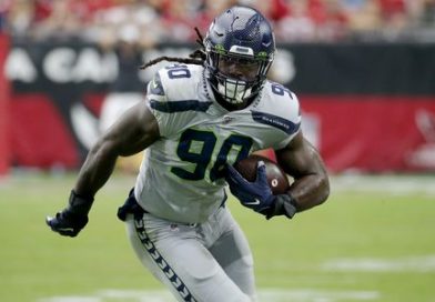 Jadeveon Clowney Running down the field with the ball in Seahawks jersey