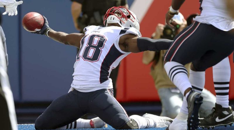 Matthew Slater - Action shot, sliding on both knees with the ball